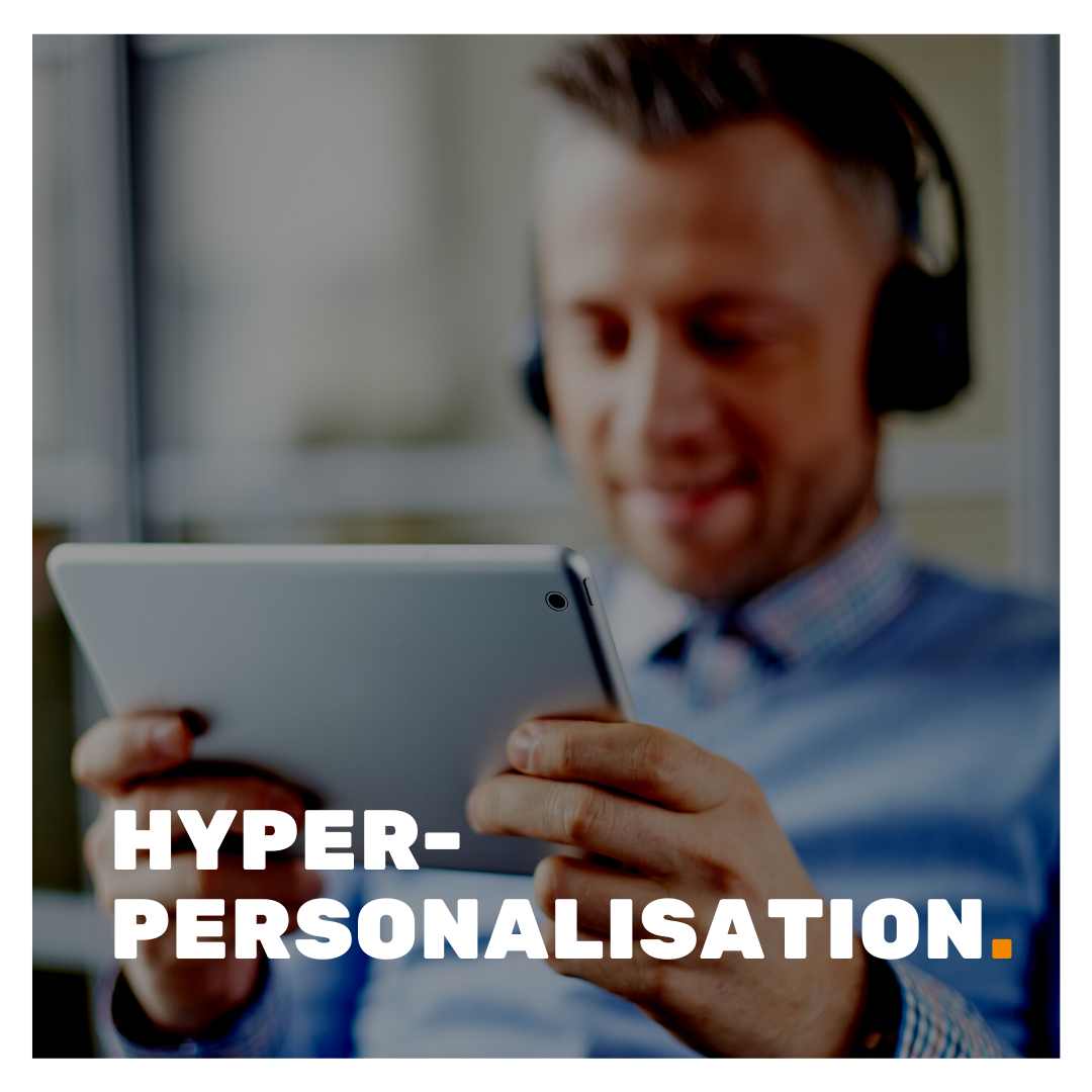 Hyper-Personalisation superimposed on a man using a tablet whilst wearing a headset