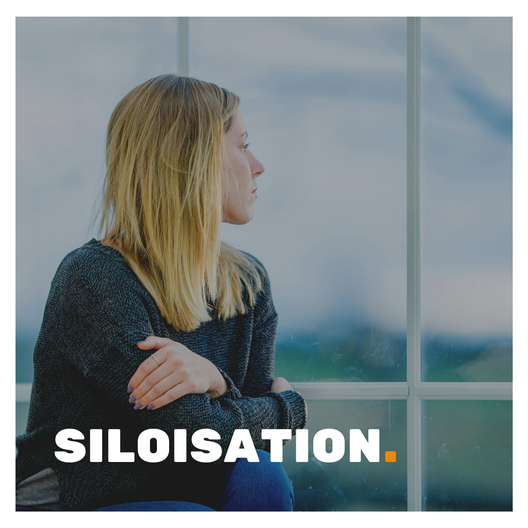 Siloisation depicted by a woman sitting on her own turning away from the camera