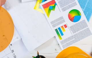 Plan projects with a picture of a laptop with several project management documents on a desk.