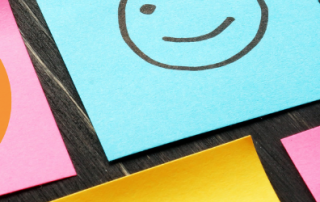 CX in insurance showing a number of post it notes with smiley faces.