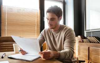 Picture of young man in office working with documents.