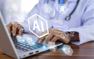 Person using a laptop on a desk with an AI symbol floating in front of it.