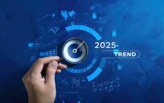 Hand holding a magnifying glass over a digital futuristic interface with '2025 Trend' displayed.